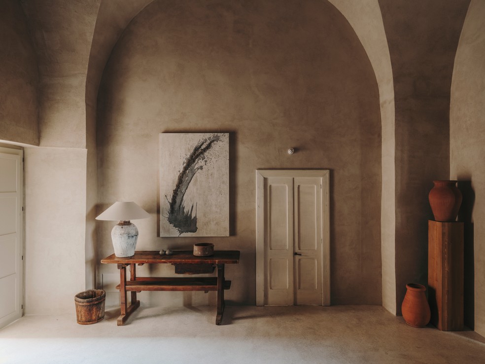 À esq., obra de arte de Eleanor Herbosh compõe decoração da sala de estar em casa na Itália — Foto: Salva López 