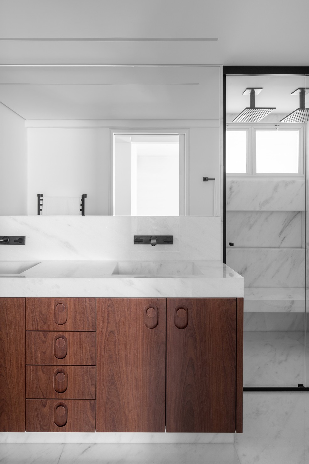 O banheiro principal tem ares minimalistas com revestimento de mármore — Foto: Carolina Lacaz