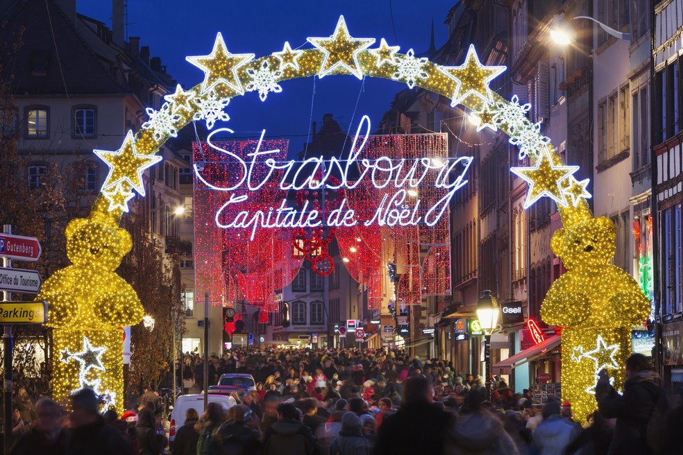 Um letreiro enorme e brilhante ilumina a entrada do mercado natalino de Estrasburgo, o Christkindelsmärik  — Foto: Getty Images/Jon Hicks