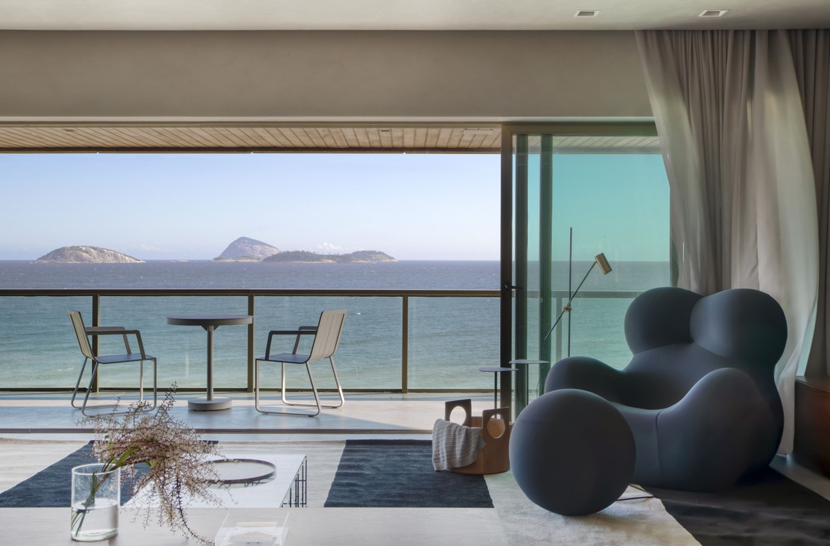 Décor do dia: área social moderna com poltrona escultural e madeira